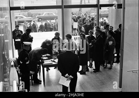 American Embassy, London, where a book of condolence has been opened for members of the public, in remembrance of assassinated American President Kennedy, Sunday 24th November 1963. Our Picture Shows ... members of public queueing inside Embassy, waiting to sign book of condolence. Stock Photo