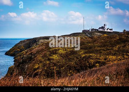 View of Point Lynas Lighthouse and Trwyn Eilian from across small Bay of Porth Eilian Stock Photo