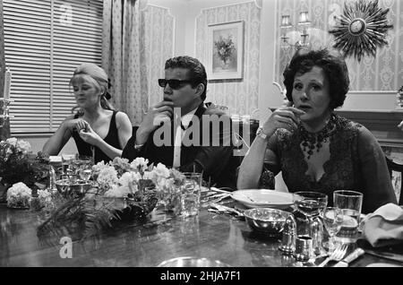 Julie Christie, actor, pictured on the set of the film  'Darling'. Also pictured on the right is Fanny Cradock.  Darling is a 1965 British drama film written by Frederic Raphael, directed by John Schlesinger, and starring Julie Christie with Dirk Bogarde and Laurence Harvey.  Darling was nominated for five Academy Awards, including Best Picture and Best Director. Christie won the Academy Award for Best Actress for her performance as Diana Scott. The film also won the Academy Awards for Best Original Screenplay and Best Costume Design.  Picture taken 16th December 1964 Stock Photo