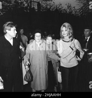 Brigitte Bardot (30) in Hampstead, London to complete a few finishing scenes for her new film Adorable Idiot.   Pictured surrounded by fans & admirers in Flask Walk, a small Hampstead street, 25th October 1963.   *** Local Caption *** Brigitte Bardot plays character Penelope Lightfeather Stock Photo