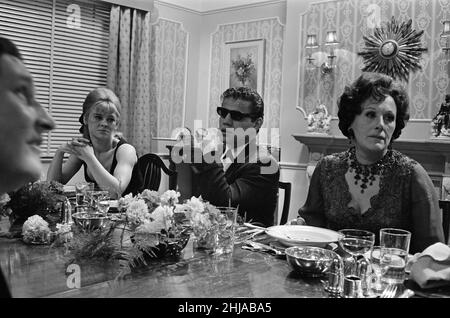 Julie Christie, actor, pictured on the set of the film  'Darling'. Also pictured on the right is Fanny Cradock.  Darling is a 1965 British drama film written by Frederic Raphael, directed by John Schlesinger, and starring Julie Christie with Dirk Bogarde and Laurence Harvey.  Darling was nominated for five Academy Awards, including Best Picture and Best Director. Christie won the Academy Award for Best Actress for her performance as Diana Scott. The film also won the Academy Awards for Best Original Screenplay and Best Costume Design.  Picture taken 16th December 1964 Stock Photo