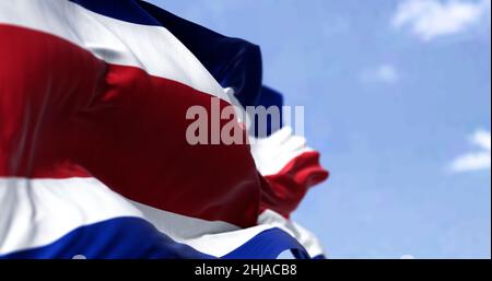 Detail of the national flag of Costa Rica waving in the wind on a clear day. Democracy and politics. Patriotism. Selective focus. Seamless Slow motion Stock Photo