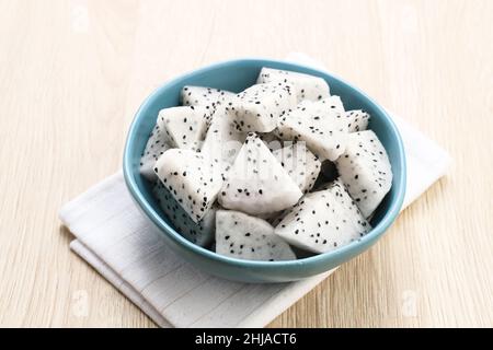 A bowl of fresh dragon fruit on wooden background. Breakfast fruit in the morning. Stock Photo