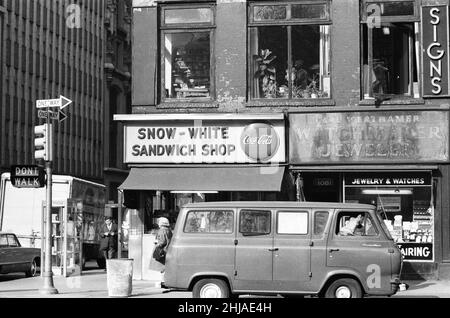 New York Scenes, Thursday 15th October 1964. Our Picture Shows ... a Ford Falcon Econoline van parked outside shops, New York City. Stock Photo