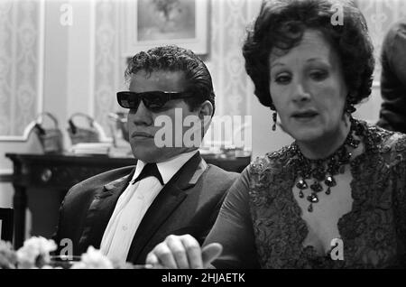 Filming on the set of the film 'Darling'. Unidentified man on the left, and Fanny Cradock on the right.  Darling is a 1965 British drama film written by Frederic Raphael, directed by John Schlesinger, and starring Julie Christie with Dirk Bogarde and Laurence Harvey.  Darling was nominated for five Academy Awards, including Best Picture and Best Director. Christie won the Academy Award for Best Actress for her performance as Diana Scott. The film also won the Academy Awards for Best Original Screenplay and Best Costume Design.  Picture taken 16th December 1964 Stock Photo