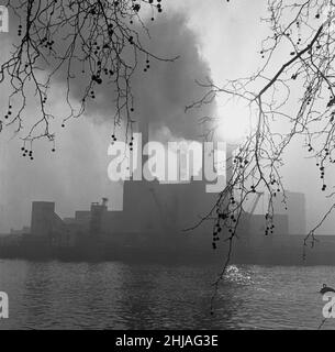 Battersea Power Station seen here on a murky foggy winters morning. London. 7th December 1962 Stock Photo