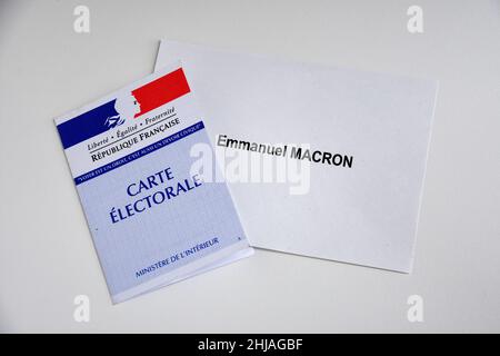 In this photo illustration, a ballot paper of Emmanuel Macron is seen displayed on a table with a voters card. Despite not officially being a candidate for re-election, the President of the French Republic, Emmanuel Macron is leading the polls for the presidential elections of 2022 with 25% of the voting intentions, putting him ahead of Marine Le Pen of the Rassemblement National (RN or National Rally) party, who polled only 17%. The first round of France's Presidential election will take place on April 10, 2022. (Photo by Gerard Bottino/SOPA Images/Sipa USA) Stock Photo