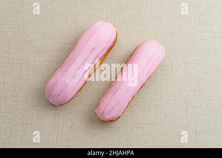 Traditional French dessert. Sweet and colorful eclairs with chocolate glaze. Stock Photo