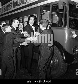 Cliff Richard and some of the Shadows with a hired London Transport bus. The cast of the film had planned to arrive at the premiere of the film,  'Summer Holiday' in the bus. Cliff Richard was prevented from attending the premier due to fans crowding round his car as it entered Leicester Square. 10th January 1963. Stock Photo