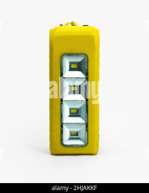 Old Yellow rough electric chargeable searchlight broken torch led flashlight Stock Photo