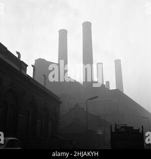 Battersea Power Station seen here on a murky foggy winters morning. London. 7th December 1962 Stock Photo