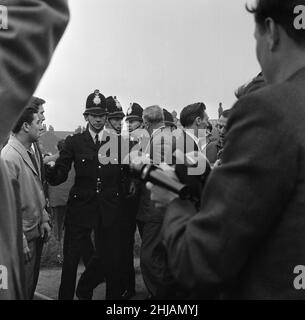 Sir Oswald Mosley visits Manchester to take part in a march organised by his British Union of Fascists supporters, Sunday 29th July 1962. When the eighty marchers gathered, an angry crowd rushed them and Mosley disappeared into a flurry of flying fists and boots and his groups banners were torn to tatters.  Police broke up the fighting mob and rescued 65-year-old Mosley but the march soon turned into a riot causing a mile of terror with fights breaking out every few yards. Many marchers fell out with bleeding faces and torn clothes. The rest were pelted with stones, coins, cabbages, tomatoes a Stock Photo