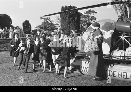 Santa Claus arrives by helicopter at Pestalozzi Village for Children in Sedlescombe, East Sussex, 17th December 1962. The community is named after eighteenth century Swiss educationalist, Johann Heinrich Pestalozzi, who devoted his life to closing divisions in society through education of the whole person – their Head, Heart and Hands. Stock Photo