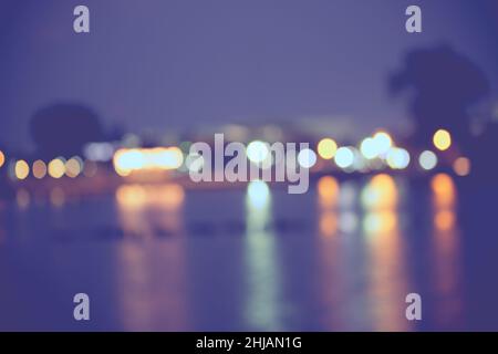 Beautiful blurred city lights with bokeh effect reflected on water background Stock Photo