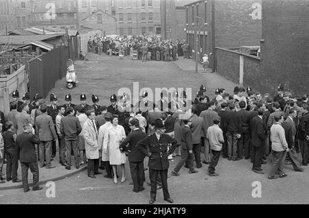 Sir Oswald Mosley visits Manchester to take part in a march organised by his British Union of Fascists supporters, Sunday 29th July 1962. When the eighty marchers gathered, an angry crowd rushed them and Mosley disappeared into a flurry of flying fists and boots and his groups banners were torn to tatters.  Police broke up the fighting mob and rescued 65-year-old Mosley but the march soon turned into a riot causing a mile of terror with fights breaking out every few yards. Many marchers fell out with bleeding faces and torn clothes. The rest were pelted with stones, coins, cabbages, tomatoes a Stock Photo