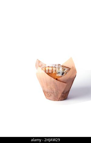 Vertical photo of an isolated muffin with chocolate and berries in the paper package. Front view. Stock Photo