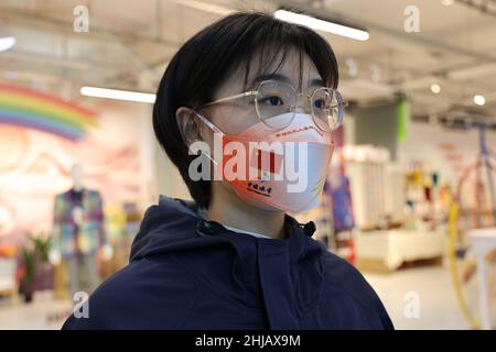 BINZHOU, CHINA - JANUARY 27, 2022 - A model presents masks for the Beijing Winter Olympic Games at Joyjoy Home Textile Co., LTD in Binzhou city, East Stock Photo