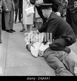 Sir Oswald Mosley visits Manchester to take part in a march organised by his British Union of Fascists supporters, Sunday 29th July 1962. When the eighty marchers gathered, an angry crowd rushed them and Mosley disappeared into a flurry of flying fists and boots and his groups banners were torn to tatters.  Police broke up the fighting mob and rescued 65-year-old Mosley but the march soon turned into a riot causing a mile of terror with fights breaking out every few yards. Many marchers fell out with bleeding faces and torn clothes. The rest were pelted with stones, coins, cabbages, tomatoes a Stock Photo