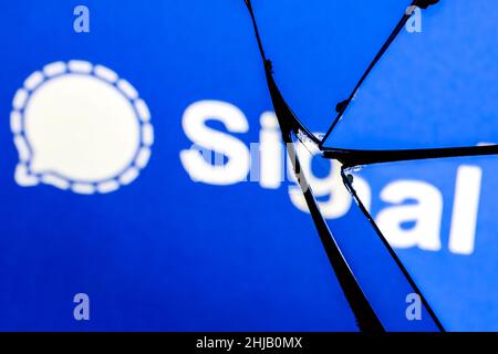 Logo of the Signal encrypted instant messaging service in the reflection of a broken mirror. The concept of problems in the work of Signal. Stock Photo