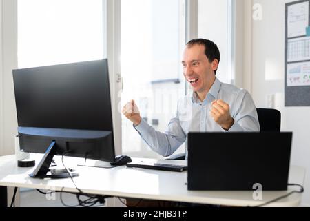 Happy Excited Man In Video Webinar On Desktop Stock Photo
