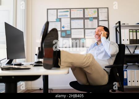 Business Man Calling Using Mobile Phone At Desk Stock Photo