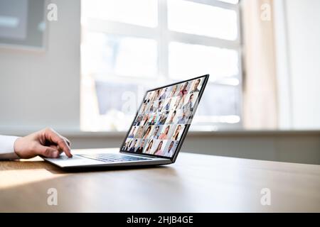 Teacher Hosting Online Class Using Video Conference On Laptop Stock Photo