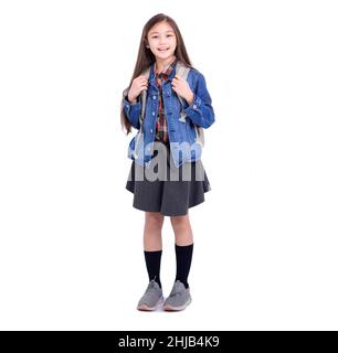 Full length portrait of a smiling girl student with backpack standing on white background Stock Photo