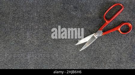 Carpeted with a cotton texture and with tailor's or seamstress's scissors. Sewing carpet production background. High quality photo Stock Photo