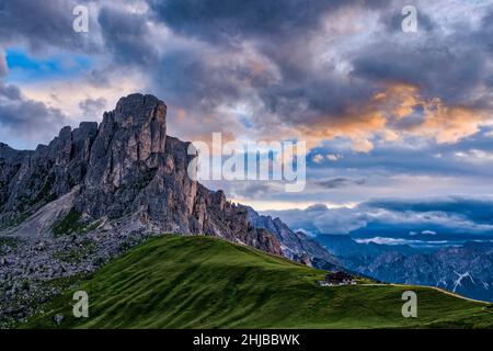 Mt. Ra Gusela and a mountain hut, seen from Punta di Zonia above Giau Pass, Passo di Giau, at sunrise. Stock Photo