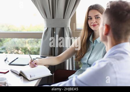 Young attractive female journalist take interview of successful businessman Stock Photo