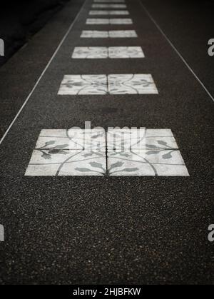 Ground level view of ornate paving stones receding into the background. Stock Photo