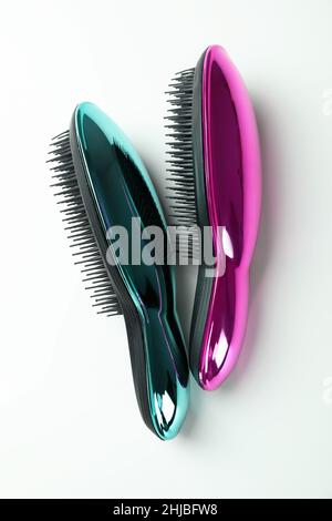 Colored plastic hair brushes on white background Stock Photo