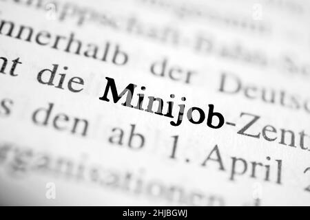 Closeup on the highlighted German word 'Minijob' in a newspaper. Stock Photo