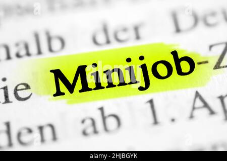 Closeup on the highlighted German word 'Minijob' in a newspaper. Stock Photo