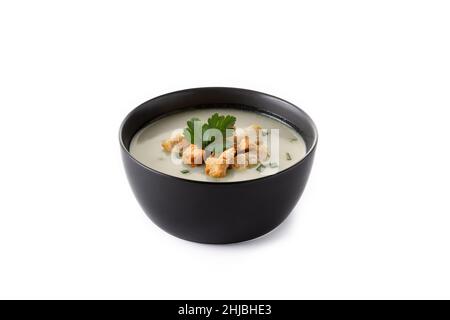 Garlic soup topped with croutons in black bowl isolated on white background Stock Photo