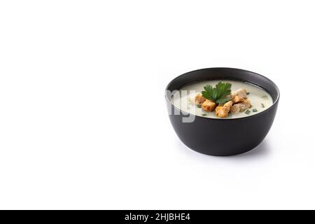 Garlic soup topped with croutons in black bowl isolated on white background Stock Photo