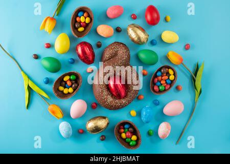 Mona de pascua cake and Easter eggs on blue background Stock Photo