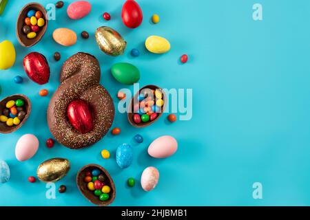 Mona de pascua cake and Easter eggs on blue background Stock Photo