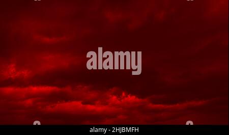 Dramatic Cloudscape Area. Dark clouds. Storm clouds backgroun. Image in dramatic dark red tone Stock Photo