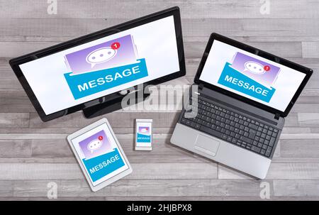 Message concept shown on different information technology devices Stock Photo