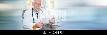 Senior doctor using tablet in office on blurred background Stock Photo