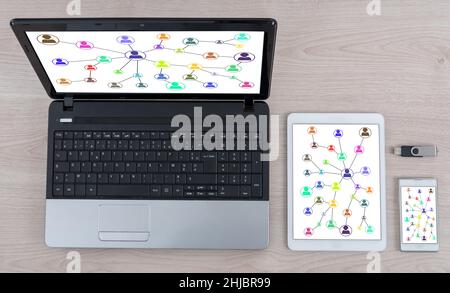 Social network concept shown on different information technology devices Stock Photo