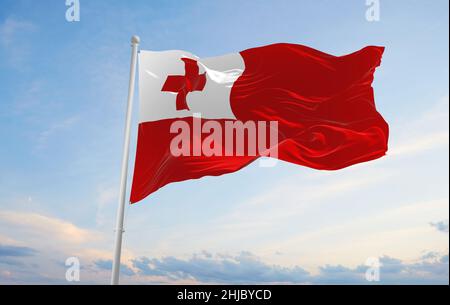 official flag of Tonga at cloudy sky background on sunset, panoramic view. patriot and travel concept. copy space for wide banner. 3d illustration Stock Photo