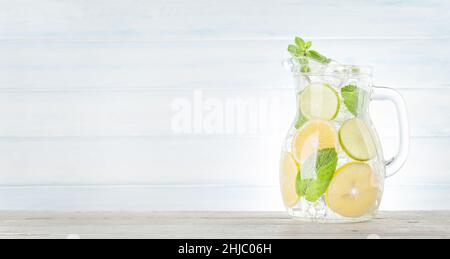 Lemonade pitcher with lemon, mint and ice cubes. With copy space Stock Photo