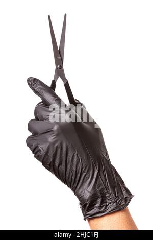 Hairdressers hand in black rubber glove holds a scissors. Isolated on white background, close-up Stock Photo