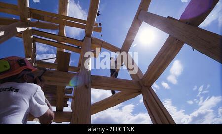 Engineer monitoring construction site. Clip. Building inspection by engineer. Foreman in a helmet monitors the construction of the house. Stock Photo