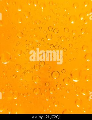 semi-abstract close up of water droplets on a light orange background Stock Photo