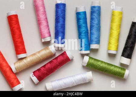 Multi-colored threads on a gray background. Stock Photo
