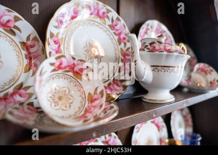 Variety of white plates bowls and tea pots for sale at store Stock Photo