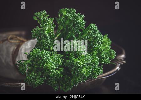 Fresh bimi vegetable on a dark table. Raw baby broccoli Stock Photo
